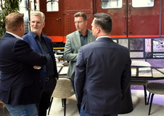 Lens Nekeman (tweede van links) en Jacco Doorn (met groen colbertje) van Interfloor in gesprek met Rob Appel (links) en een collega van Holland Haag.